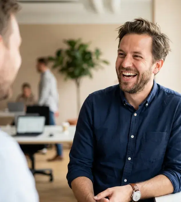 Nivara colleague laughing during a relaxed moment in the office