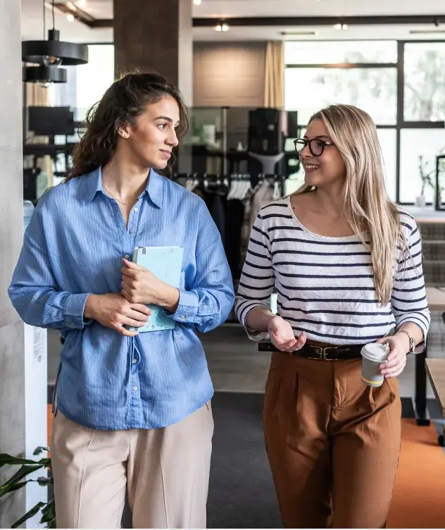 Two Nivara colleagues chatting together during a coffee break