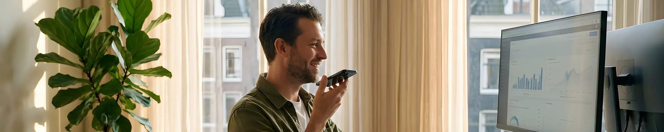Person taking a phone call at a sunlit home-office desk